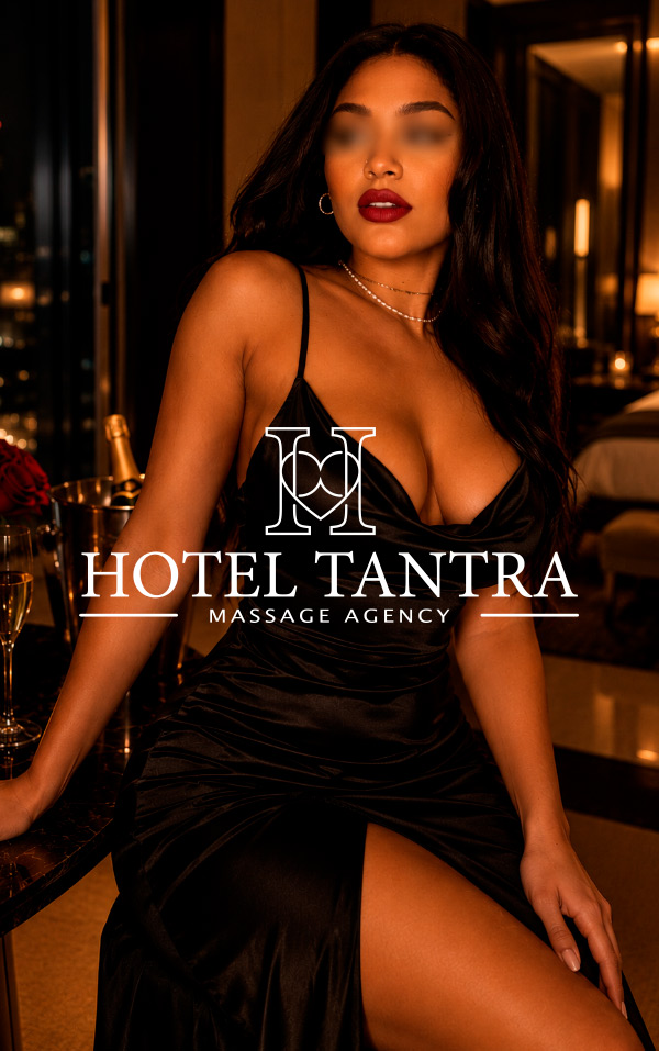 Advertisement image of a woman in a black satin dress seated at a hotel bar, blurred eyes and bold red lips, with a prominent 'Hotel Tantra Massage Agency' overlay.